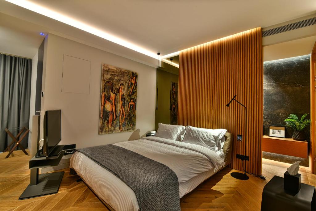 Posteľ alebo postele v izbe v ubytovaní Athens Dom Hotel