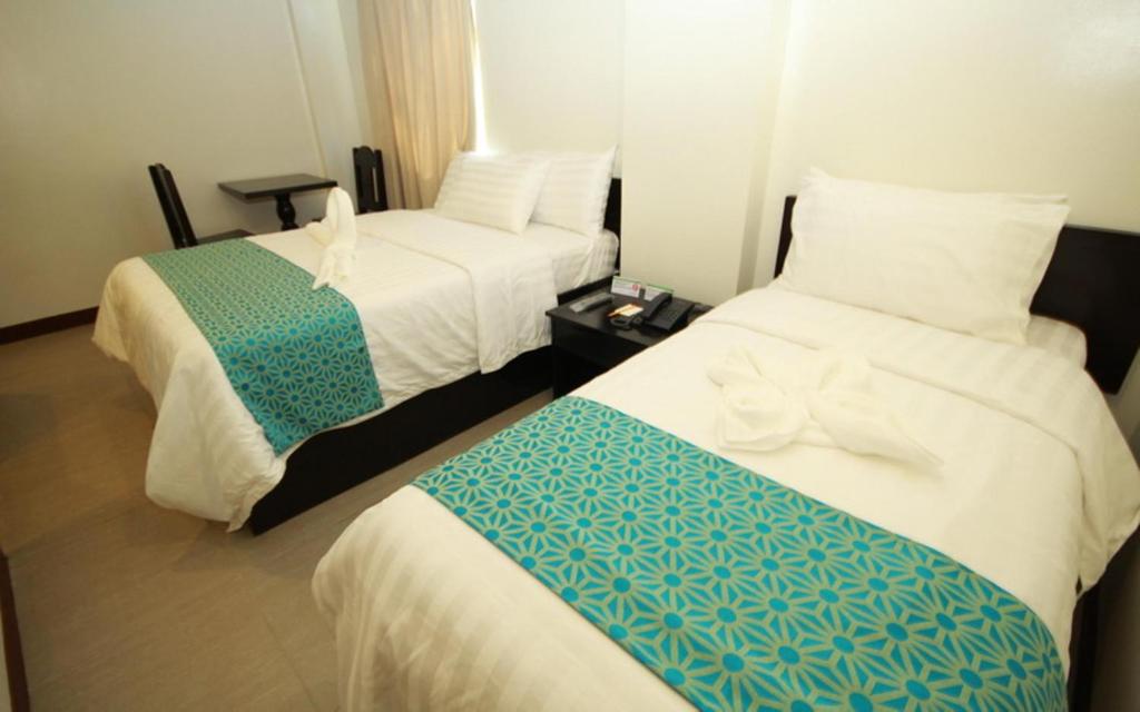 Postel nebo postele na pokoji v ubytování The Orient Beach Boracay