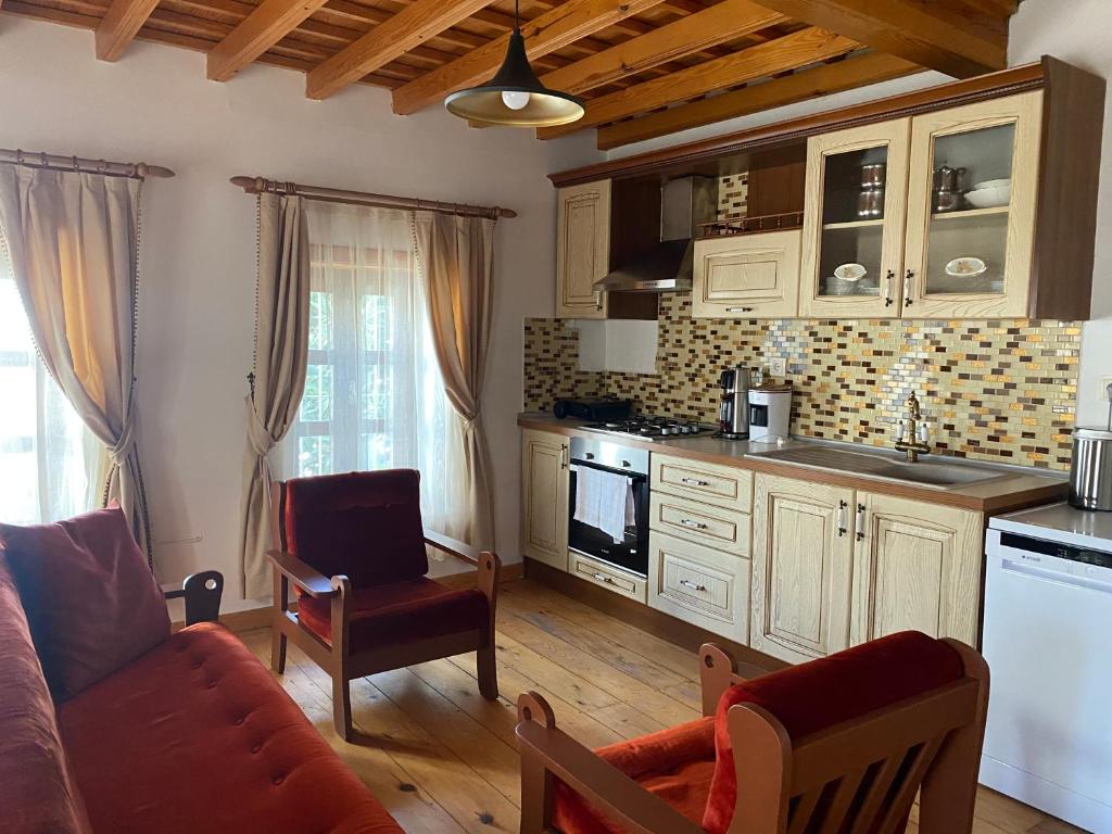 a living room with a kitchen and a couch and a table at Trea Homes - Castle House in Marmaris