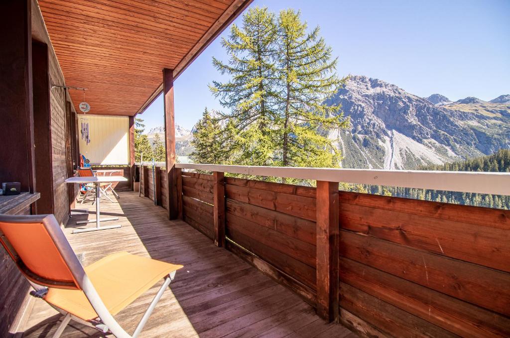 a deck with a chair and a view of a mountain at Miraflor Angela by Arosa Holiday in Arosa