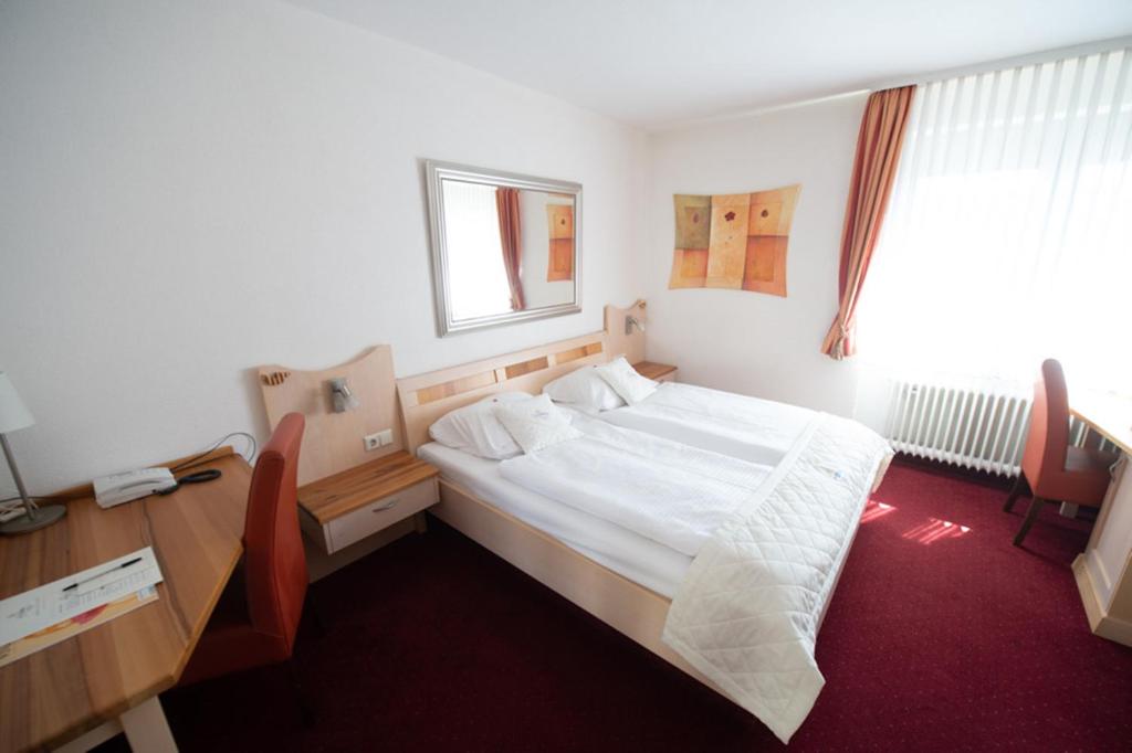 Postel nebo postele na pokoji v ubytování Hotel Trapp
