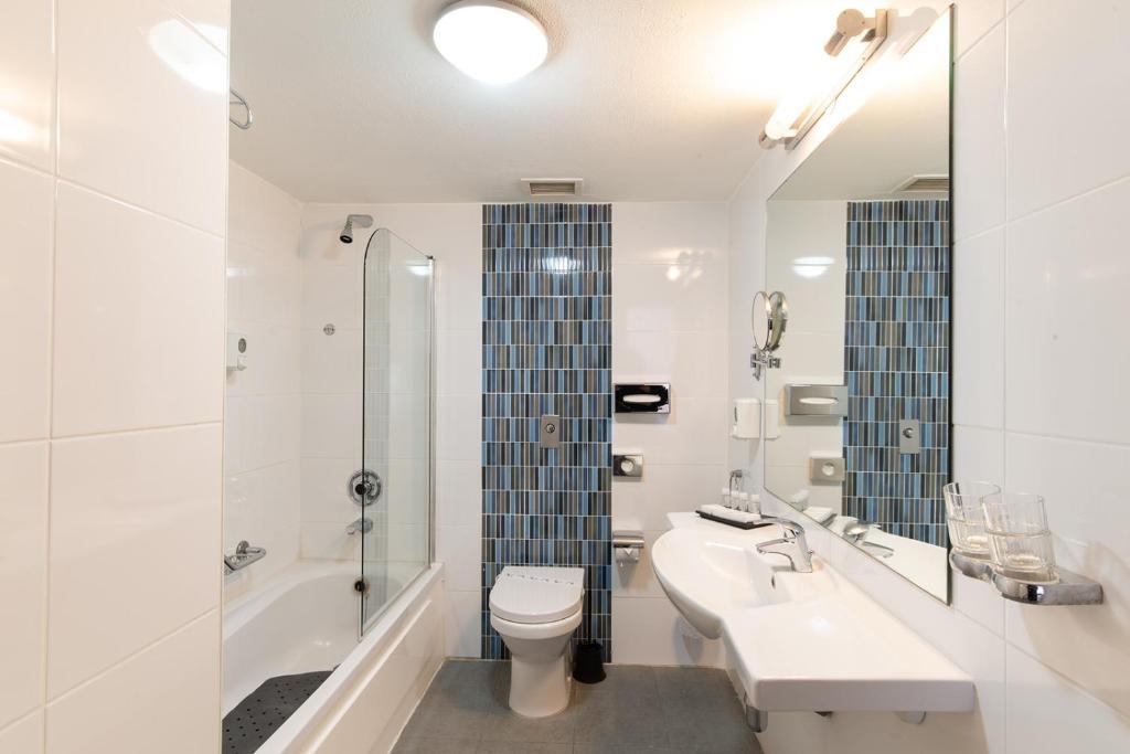 a bathroom with a sink and a toilet and a shower at The Preluna Hotel in Sliema