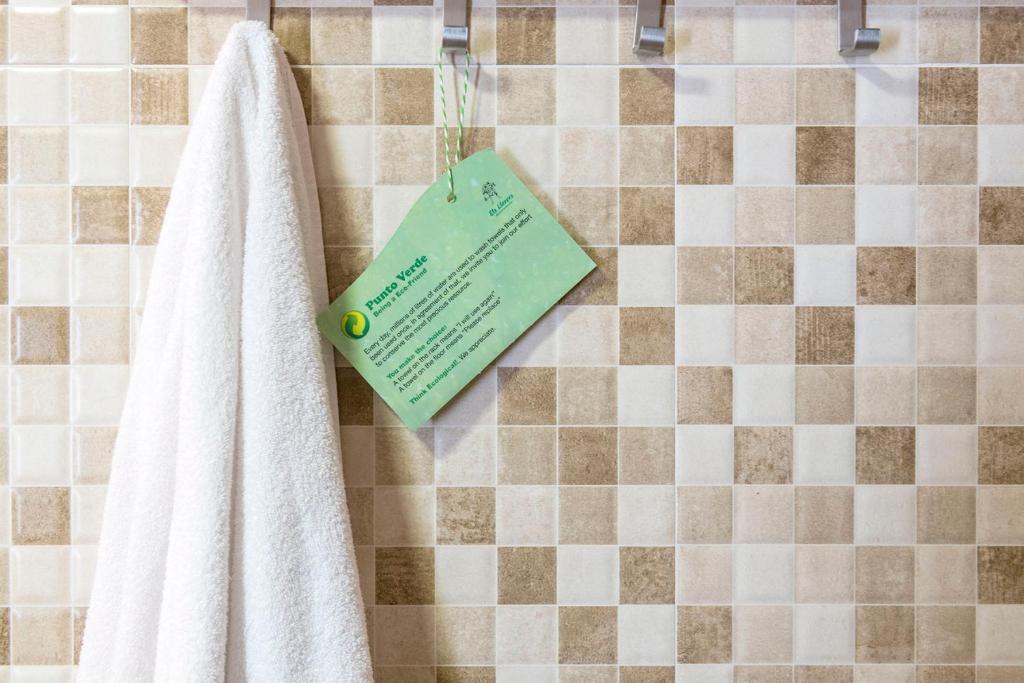a bathroom with a towel and a piece of paper at Apartaments Els Llorers in Lloret de Mar