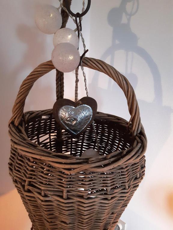 a basket with a heart hanging from it at La Pause in Plombières