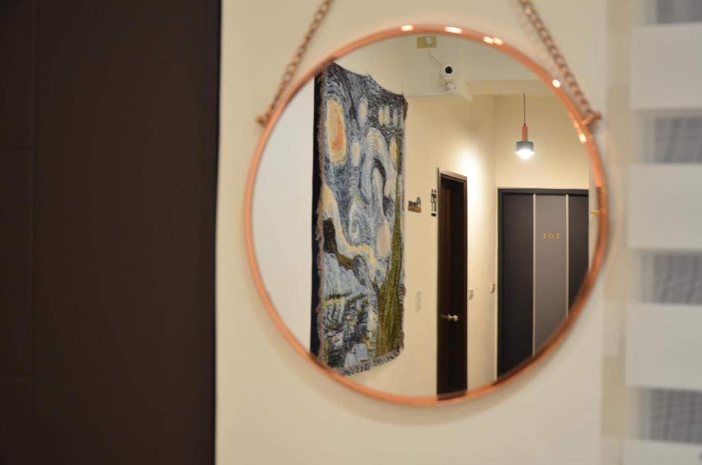 een spiegel aan een muur in een badkamer bij Full house in Taitung