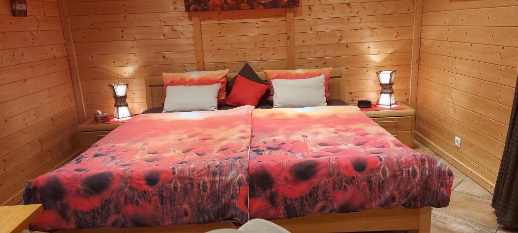 a bedroom with a bed in a wooden room at Pfalz-Apartment Mein Chalet - Einzigartig in Großkarlbach in Großkarlbach