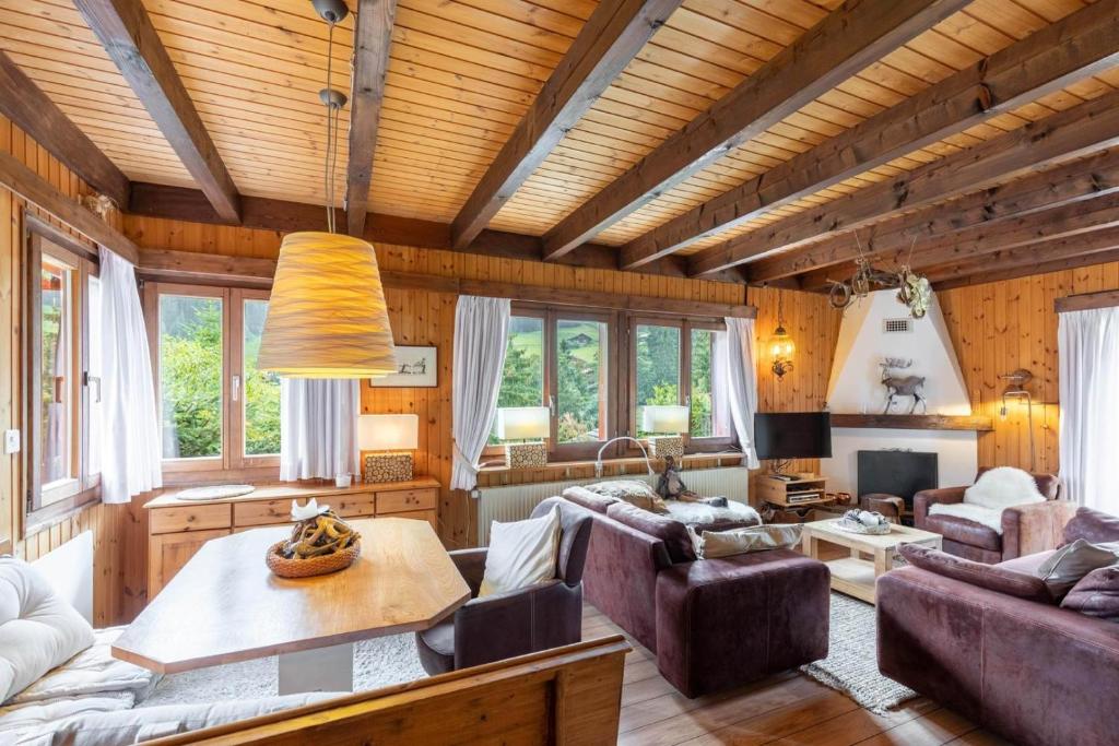a living room with a couch and a table at Chalet ChouChou in Morgins