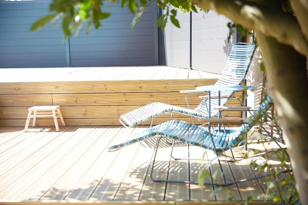 two chairs and a table on a patio at Demeure de Manneville - SPA - 1Km des plages de Cabourg in Dives-sur-Mer