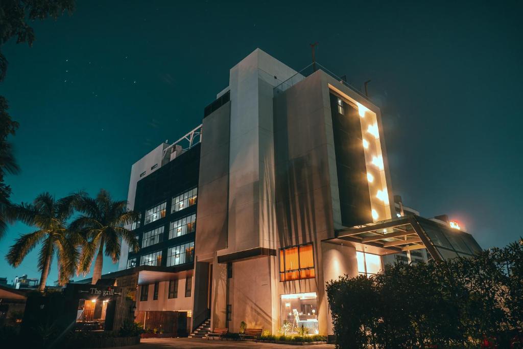 um grande edifício com luzes acesas à noite em Jardin Hotels em Indore
