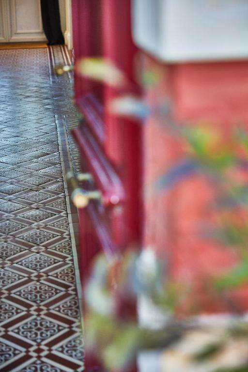 a blurry picture of a hallway with a red wall at Demeure de Manneville - SPA - 1Km des plages de Cabourg in Dives-sur-Mer