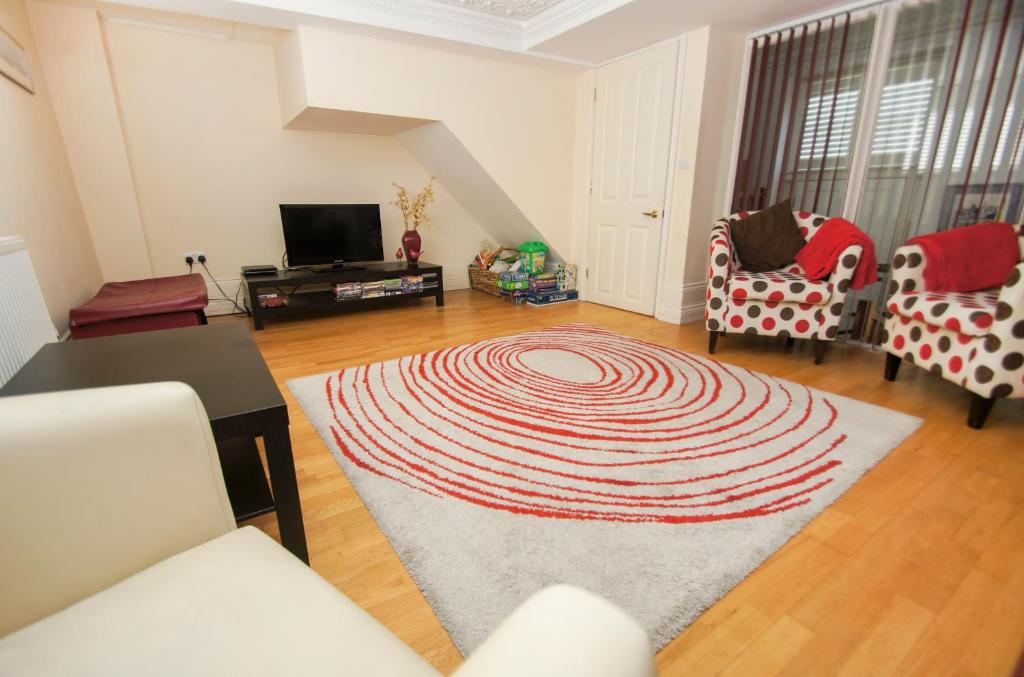 a living room with a rug on the floor at Kemp Town House - Parking - by Brighton Holiday Lets in Brighton & Hove