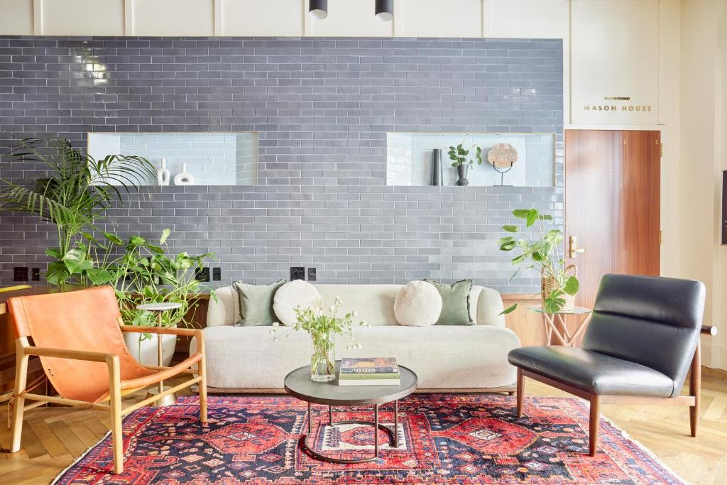 a living room with a couch and a table and chairs at Found Union Square powered by Sonder in San Francisco