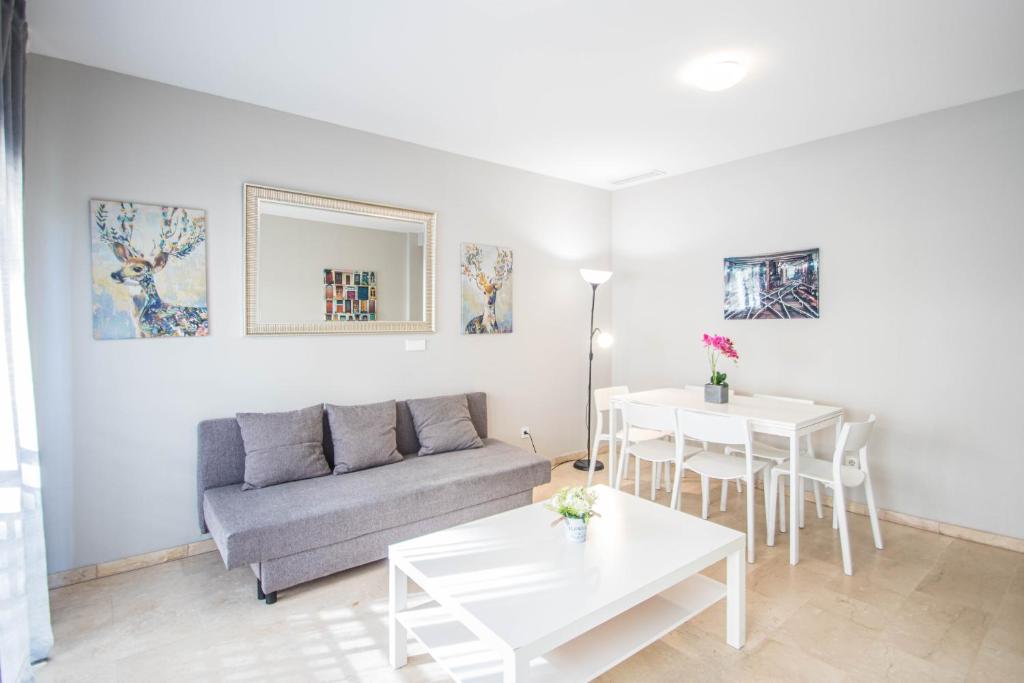 a living room with a couch and a table at Recogidas Apartment 23 in Granada