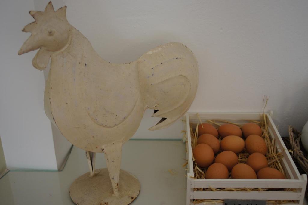 a statue of a chicken next to a box of eggs at Hotel Cyclades in Parikia