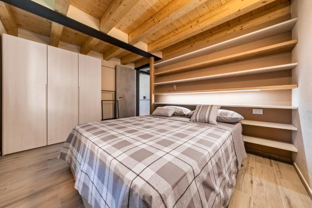 A bed or beds in a room at Maison Duc Apartments Alloggio ad uso turistico - VDA - JOVENÇAN - 0003 Alloggio ad uso turistico - VDA - JOVENÇAN - 0004