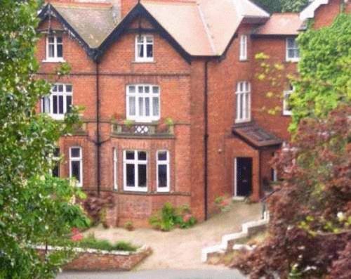 a large red brick house with white windows at Big Sky Guest House- ROOM ONLY in Whitby