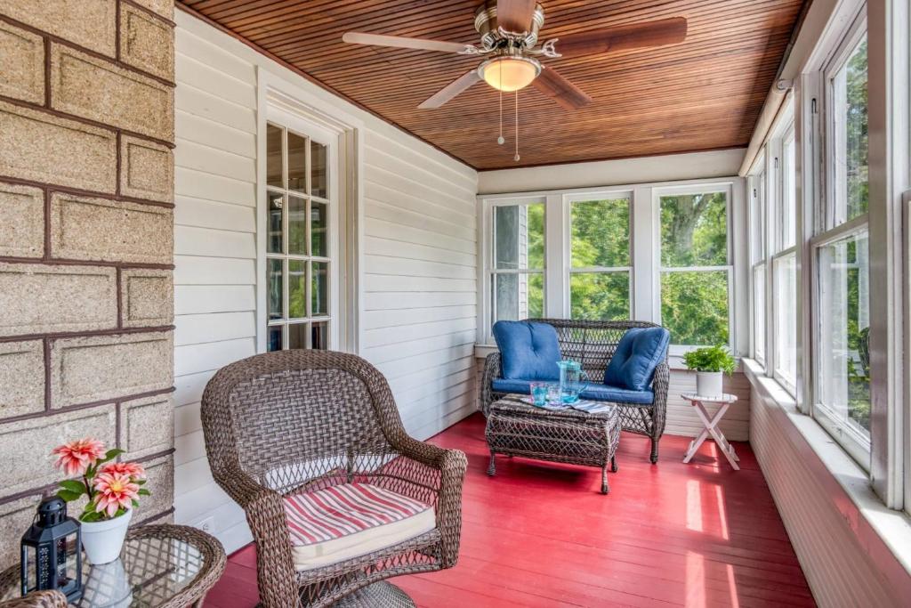 a porch with wicker chairs and a ceiling fan at 16 Saragossa Street B in St. Augustine