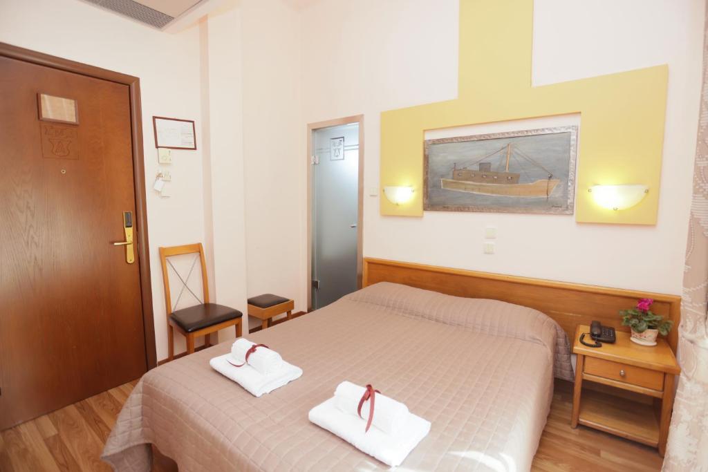 Postel nebo postele na pokoji v ubytování Aegeon Hotel