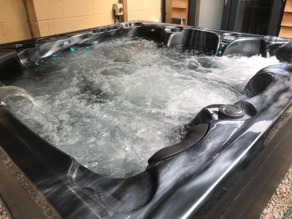 a hot tub filled with water in a room at Aiskew Villa Annex in Bedale