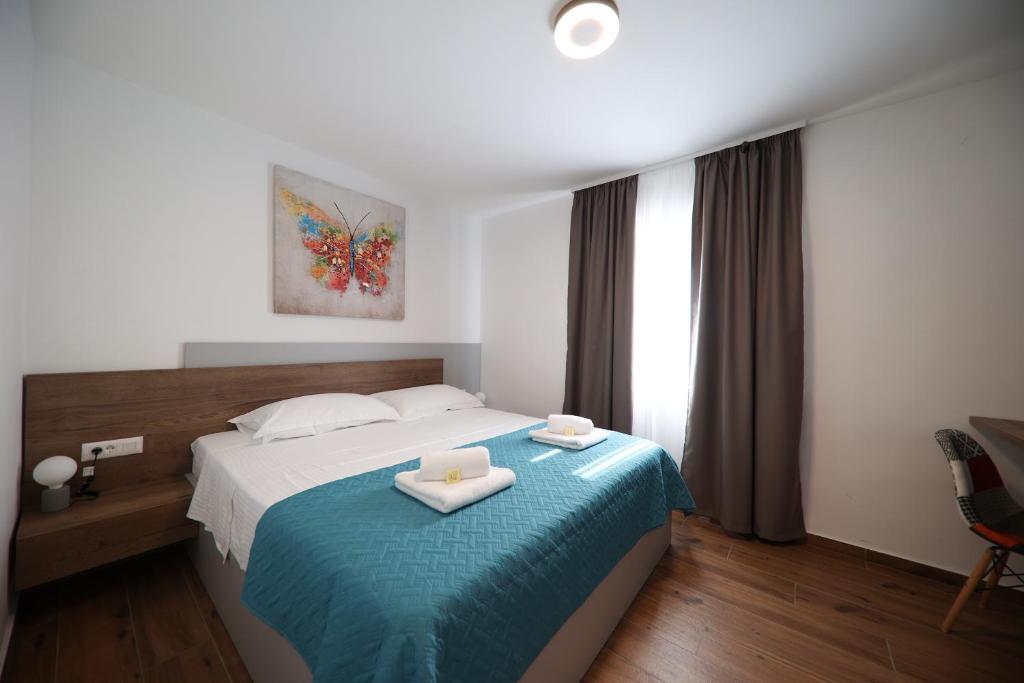 Posteľ alebo postele v izbe v ubytovaní Apartmani Diklo