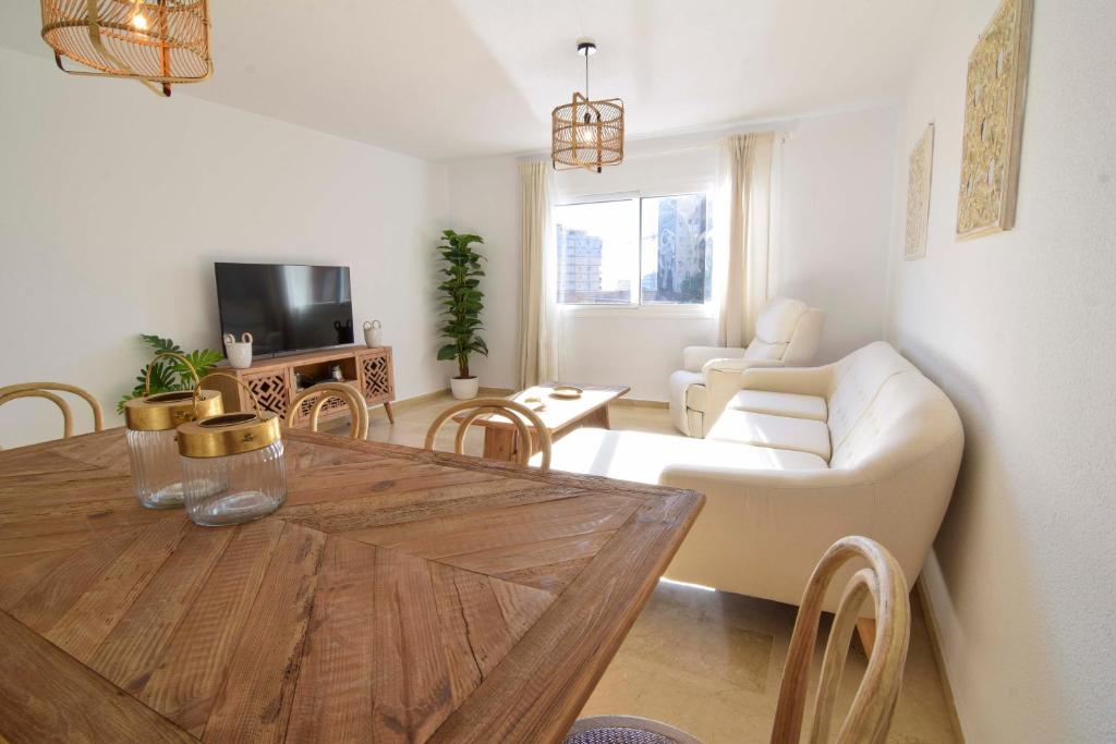 a living room with a table and a couch at Letmalaga River Views in Málaga
