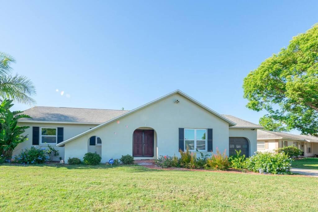 a house with a green lawn at Perfect Gateway to Disney and Retreat Center. in Deltona