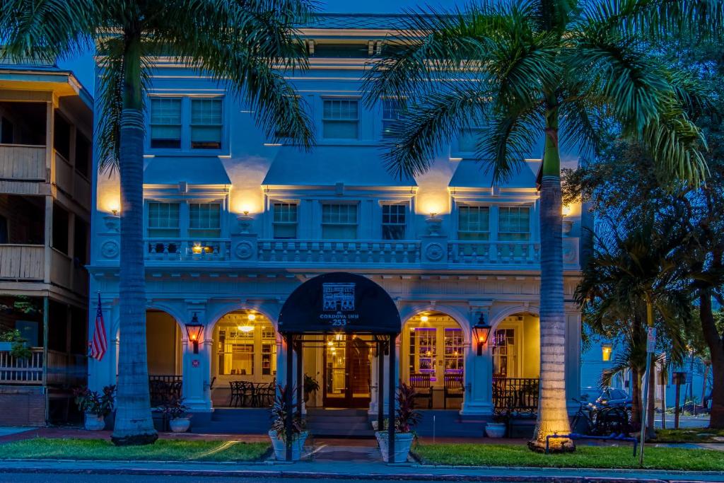 a hotel with palm trees in front of it at New Hotel Collection Downtown St Pete in St Petersburg