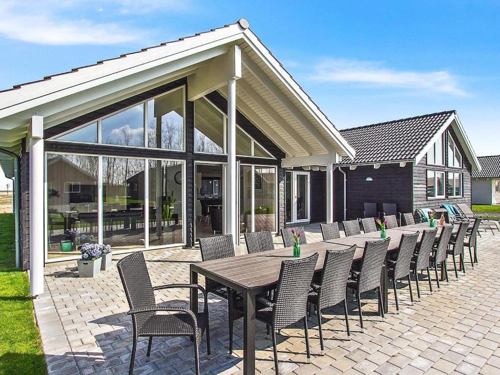 a patio with a wooden table and chairs at 18 person holiday home in Hasselberg in Kappeln