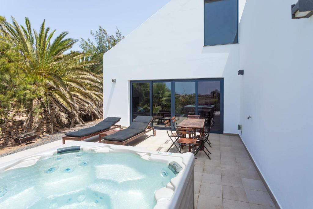 a hot tub on the patio of a house at Casa Julia, Cotillo Beach, Sea View, Fuerteventura in El Cotillo