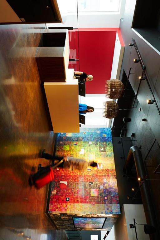 an overhead view of a room with a painting on the floor at Alt Hotel Halifax Airport in Enfield