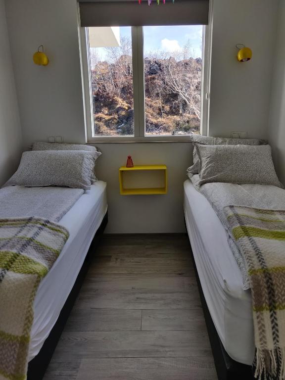 Postel nebo postele na pokoji v ubytování Mývatn apartments