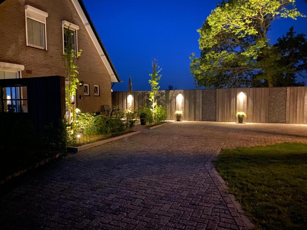 a driveway leading to a house at night at Veldzicht in Klarenbeek