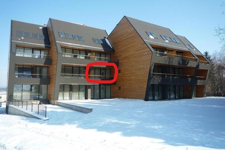 a building with a red circle on the side of it at Apartma Runi pod Zlato lisico in Pekre