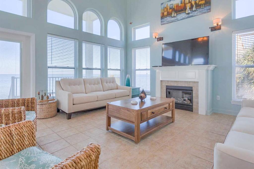 a living room with a couch and a fireplace at Serenity On The Bay in Fairhope