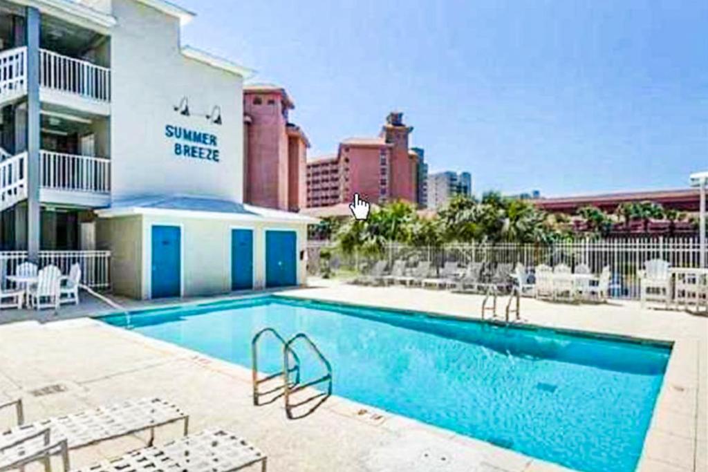 a swimming pool in front of a hotel at Summer Breeze 21 in Orange Beach