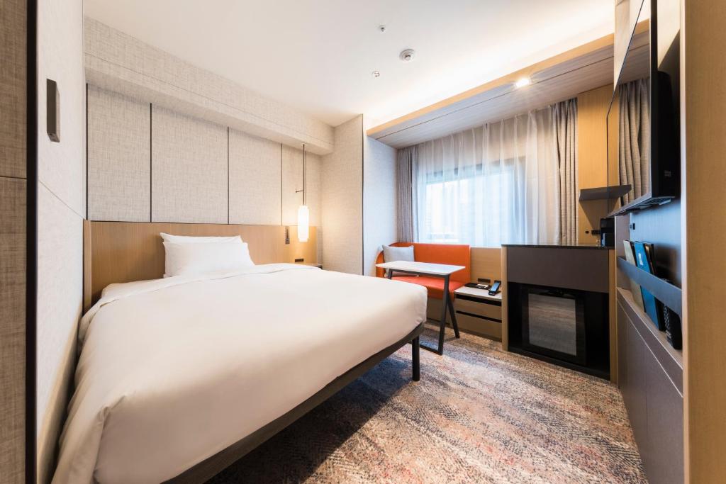 Postel nebo postele na pokoji v ubytování Hotel Metropolitan Edmont Tokyo