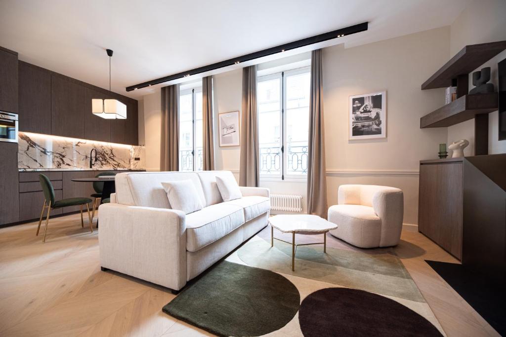 a living room with a white couch and two chairs at MBM - Luxury home in marais in Paris
