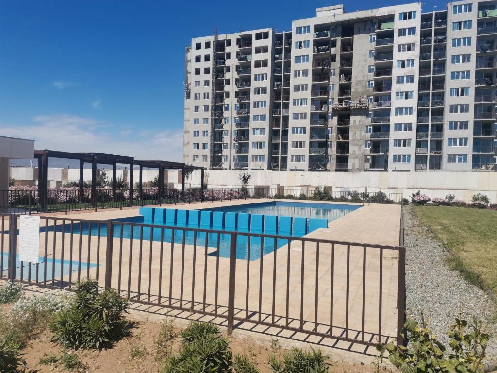 ein Schwimmbad vor einem großen Gebäude in der Unterkunft Hermoso departamento full equipado in Coquimbo