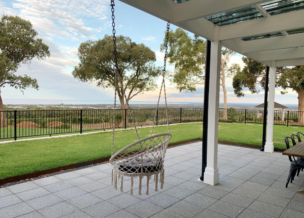 eine Schaukel auf einer Veranda mit Parkblick in der Unterkunft Yungarra Estate in Dunsborough