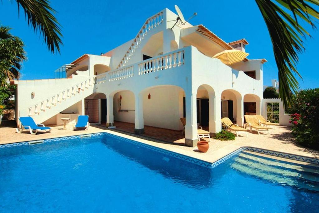 a house with a swimming pool in front of it at Holiday Home Praia da Luz - ALG01376-F in Mato Porcas