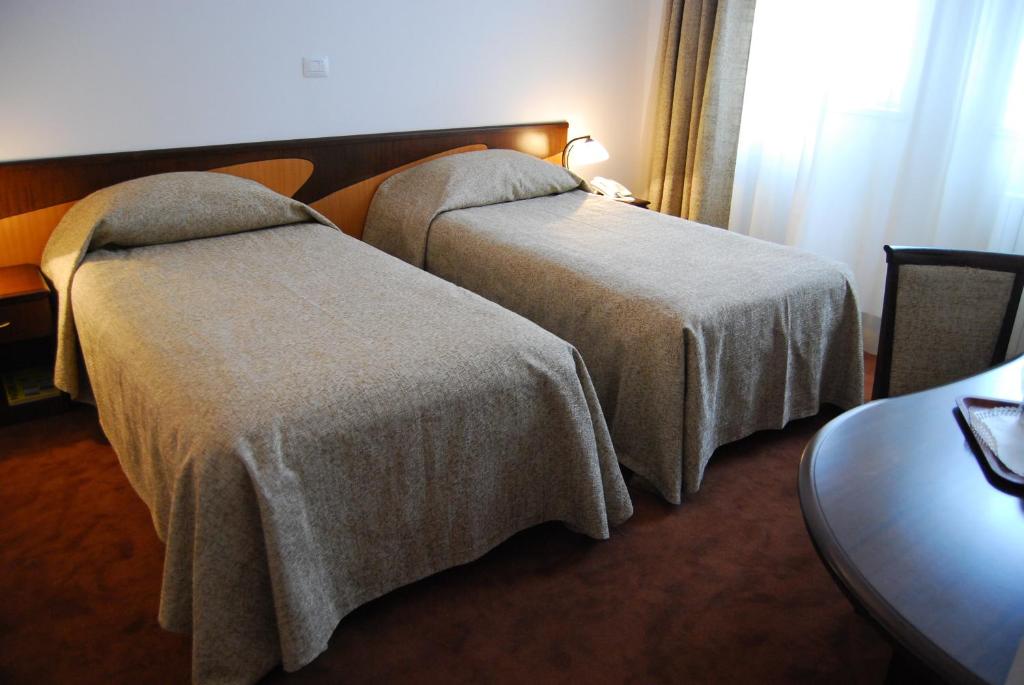 Postel nebo postele na pokoji v ubytování Hotel Maria