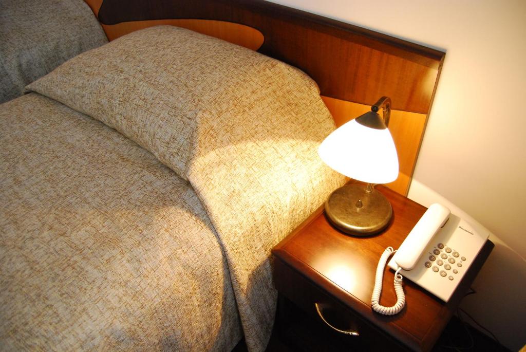 Postel nebo postele na pokoji v ubytování Hotel Maria