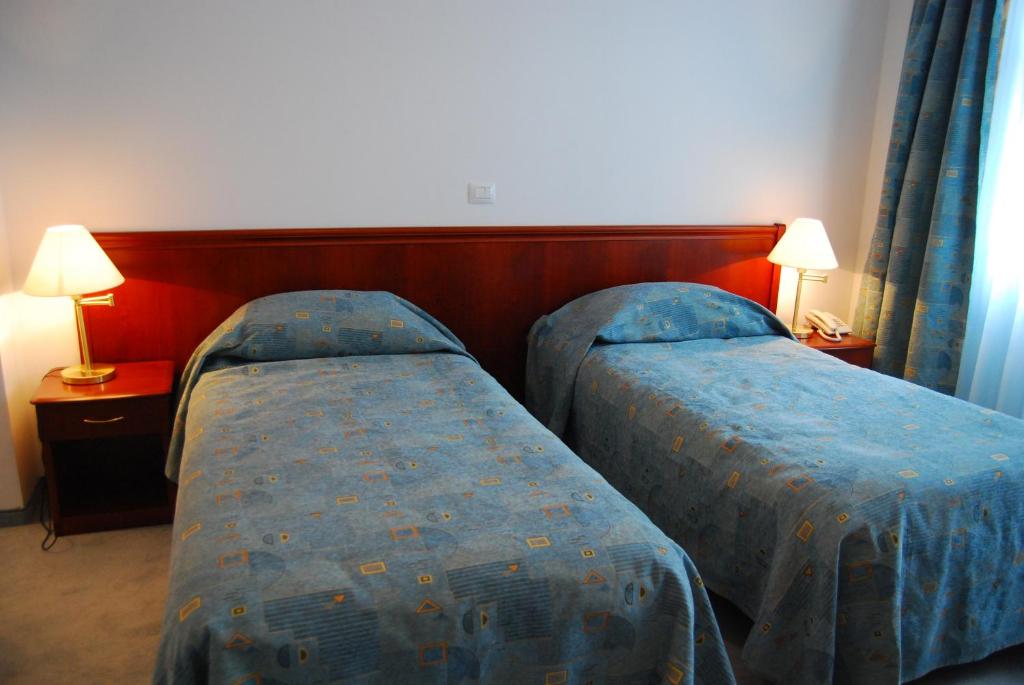 Postel nebo postele na pokoji v ubytování Hotel Maria