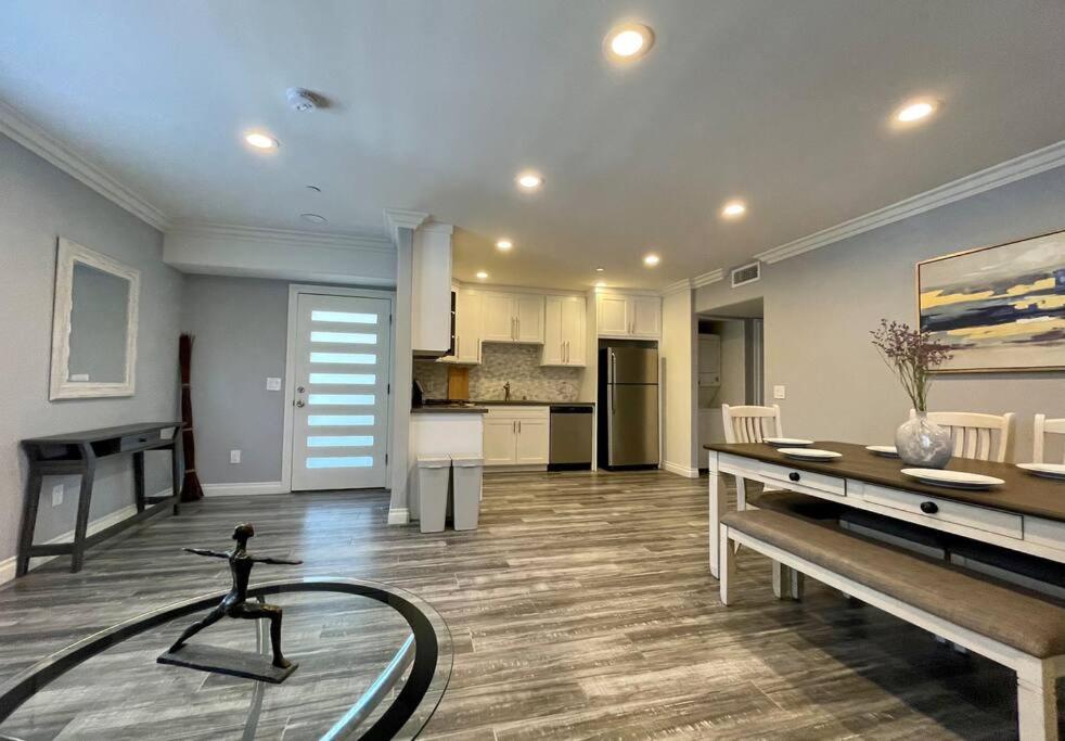 a large living room with a table and a kitchen at Newly Built Townhouse - Prime Hollywood Location in Los Angeles