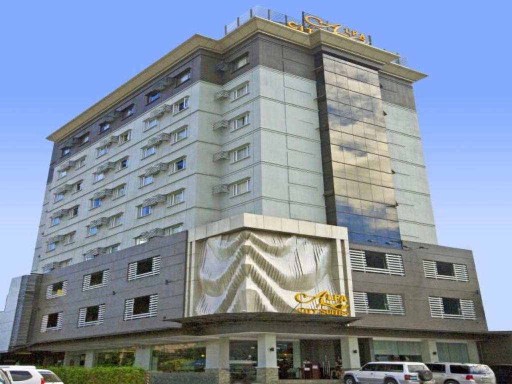 a large building with a painting on the side of it at Alpa City Suites Hotel in Cebu City