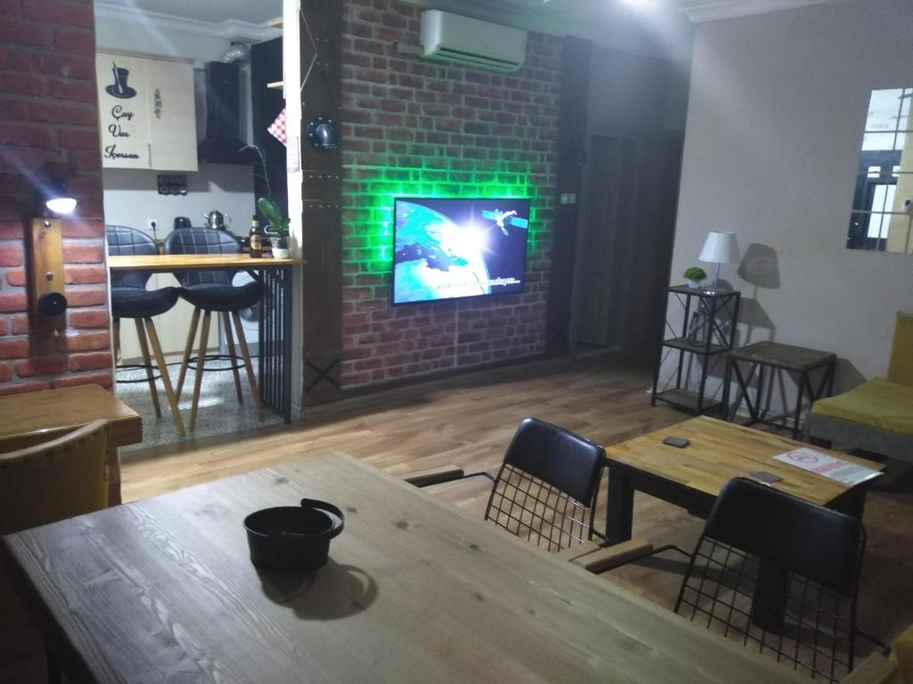 a dining room with a table and a green light at Happy Accomation Houses 192mt toHarbour in Marmaris