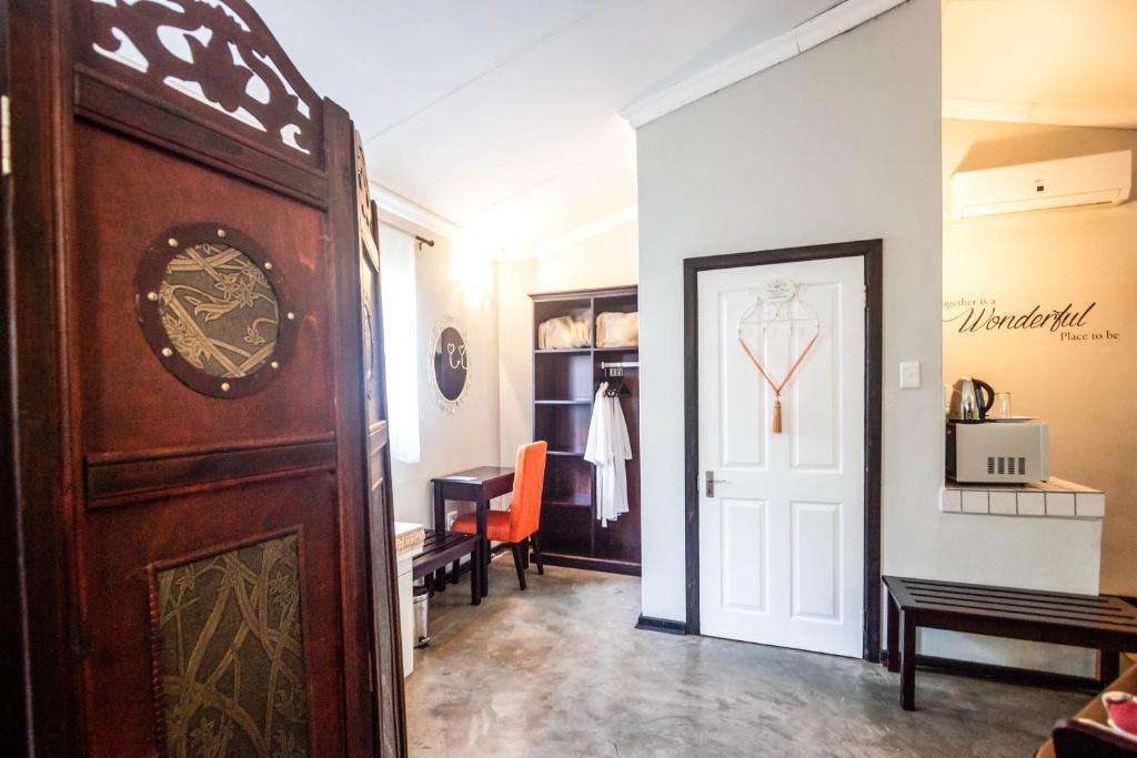 a hallway with a door leading to a room at Winterton Country Lodge @ Rose Cottage in Winterton