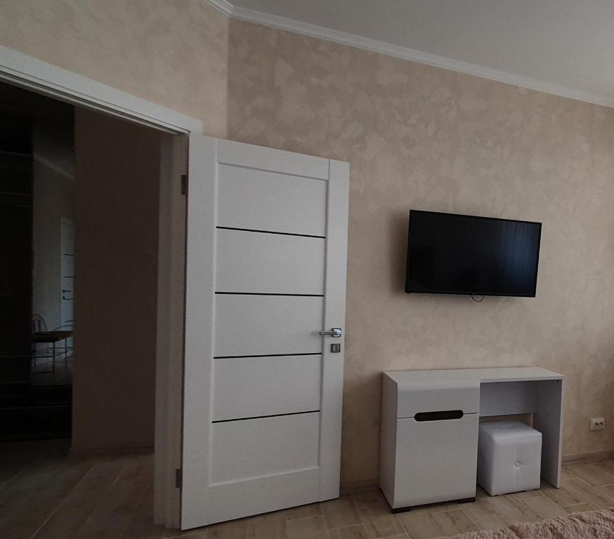a room with a door and a television on the wall at апартаменти квартира in Chortkiv