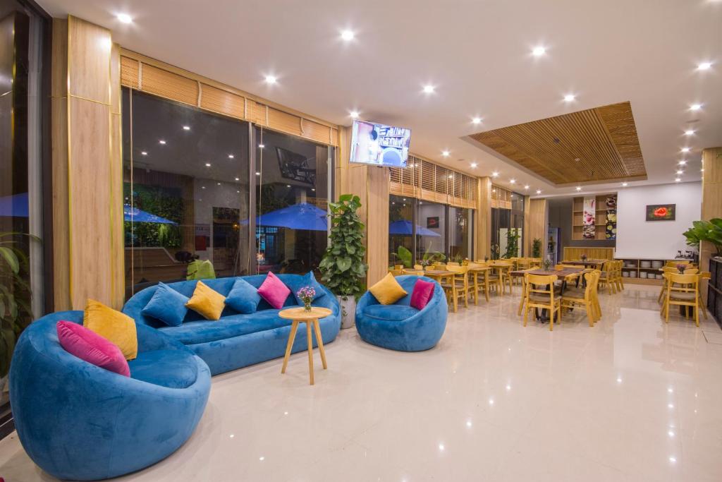 A bright lobby combines colorful lounge seating with a wooden dining area.