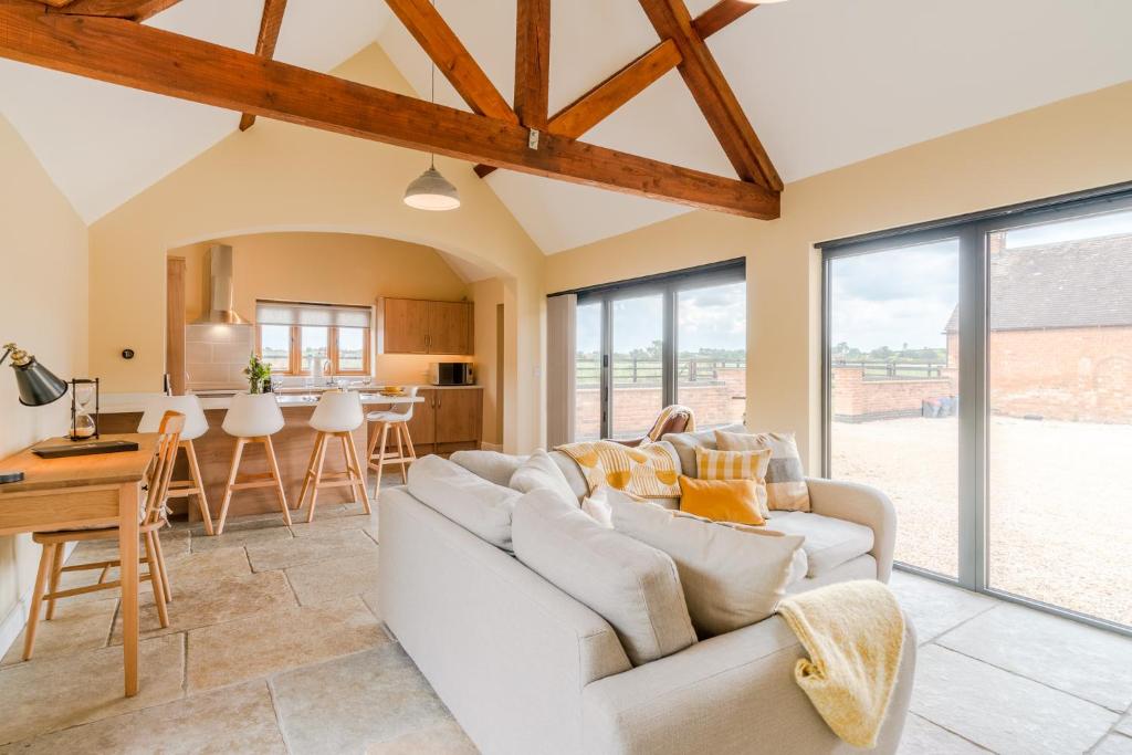 a living room with a white couch and a table at Swifts Retreat in Bidford